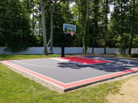 View of heavily shaded basketball court from left front toard right rear in Taunton, MA.