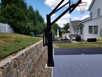 Residential backyard basketball court in charcoal and titanium colors in Wellesley, MA.