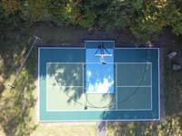 Drone view straight down at comboned backyard pickleball and basketball court in Westport, MA.