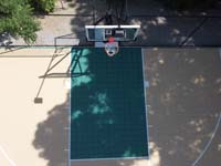 Drone view of hoop and key area of residential basketball court in Westwood, MA.