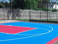 Light blue and red residential basketball goal system, containment fence and court surface in Halifax, MA.