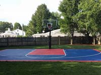 Navy and red backyard basketball court in Canton, MA.