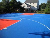 Near professional size home basketball court in Bellingham, MA, with royal blue and orange colors.