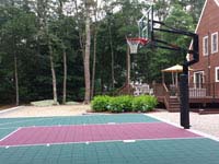 Backyard basketball court in Versacourt slate green and burgundy outdoor tile colors in Dartmouth, MA.