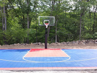 Navy blue and red backyard basketball court installation in North Attleboro, MA.