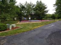 View of red and grey home basketball court in Groton, MA.