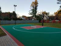 Rust and emerald green court with a custom logo, installed in Londonderry, NH.