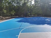 Large royal blue and titanium basketball court with golf seahorse logo at Bay Club in Mattapoisett, MA.