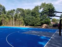 Commercial royal blue and titanium basketball court with golf seahorse logo at Bay Club in Mattapoisett, MA.