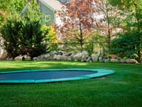 Optional in-ground trampoline included with court installation in Pembroke, MA.