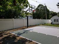 Small slate green and titanium residential basketball court in Reading, MA.