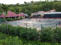 Old, worn Caribbean tennis court before restoration at Sandals Grande Antigua Resort and Spa in St. Johns, Antigua.