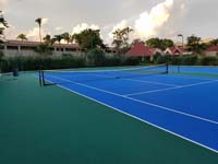 Large commercial Caribbean tennis court resurfacing project shown mostly done in St. John's, Antigua and Barbuda. 
