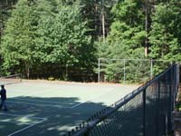 Large apartment complex tennis and multi-use court waiting to be resurfaced in Duxbury, MA.