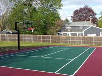 Setting up post on right for optional tennis and volleyball net to cross court from basketball hoop post for backyard basketball court in Sudbury, MA.