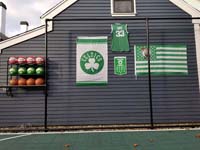 Backyard basketball court is the sort of thing you might find in Wakefield, MA or a yard like yours. Showing off customer embellishments to their court area, with basketball rack, Celtics banners, and Larry Bird shirt.