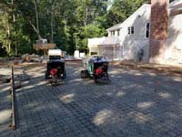Pouring cement underlay for graphite and orange residential basketball court replacing a dead pool in Walpole, MA.
