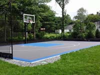 Graphite and light blue residential backyard basketball court in West Bridgewater, MA.