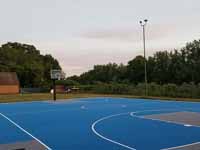 Resurfaced municipal basketball courts in Walpole, NH to create a combo of pickleball and basketball on comfortable, durable royal blue and graphite versacourt tile.
