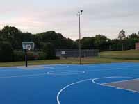 Resurfaced municipal basketball courts in Walpole, NH to create a combo of pickleball and basketball on comfortable, durable royal blue and graphite versacourt tile.