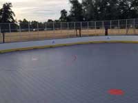 Photo from Scottsdale, Arizona installation of inline skating hockey rink for NHL Coyotes and the Boys and Girls Club, at Laguna Elementary. Removal of old surface, prep, installation of Versacourt IceCourt Outdoor Speed tile, and finished surface with custom logos.